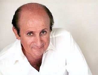 A Picture of Terry Camilleri in a white shirt.